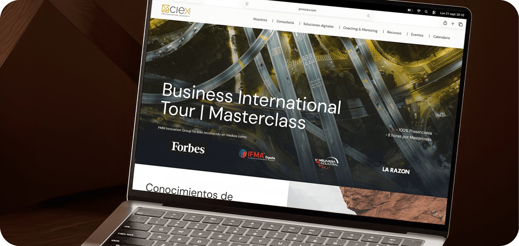 Un portátil sobre una mesa de madera, con la web de PMM CIEx abierta en el Business International Tour